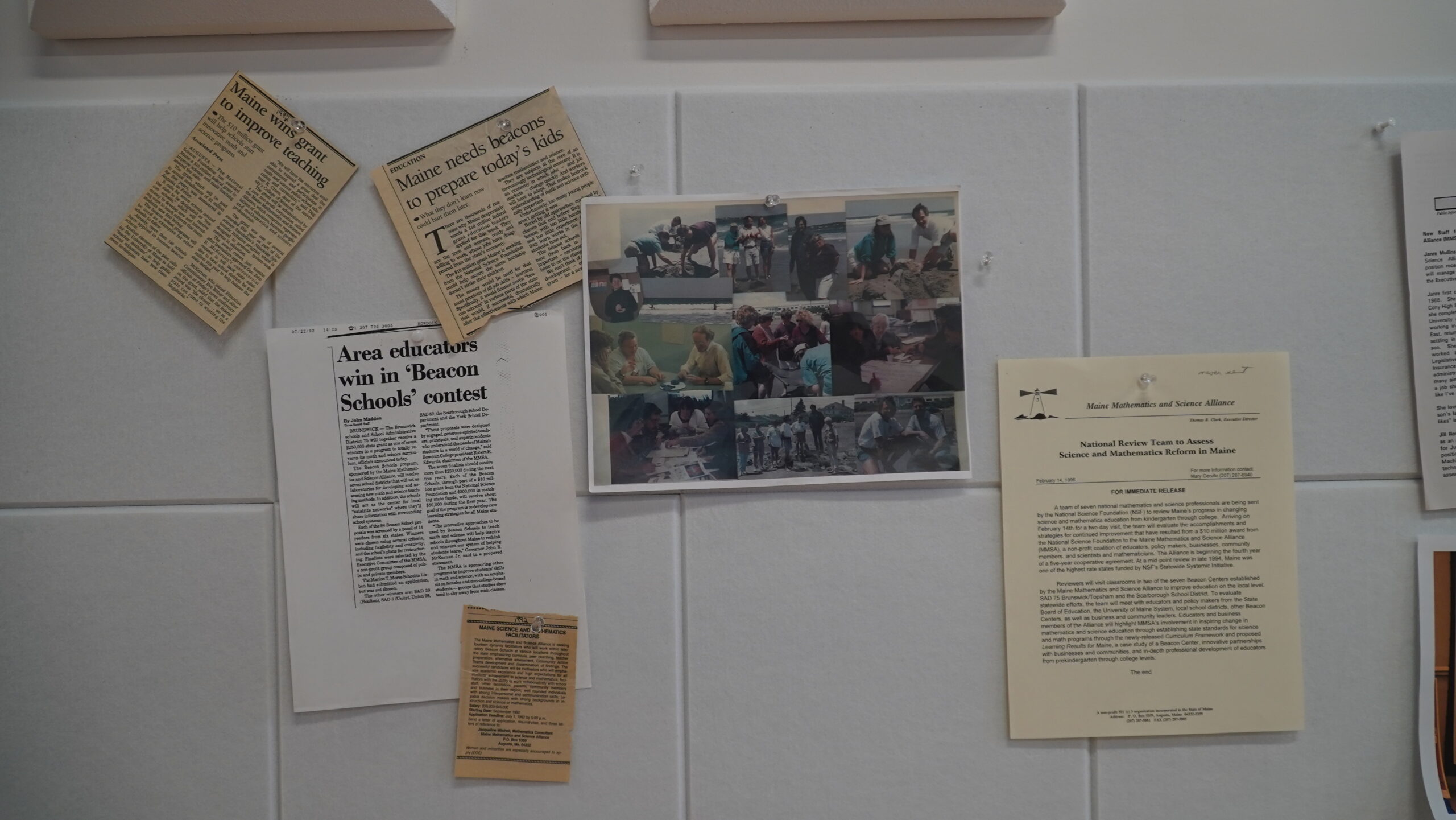 Assorted newspaper clippings from MMSA's founding as well as a collage of photos of past staff and events hung as a part of the timeline on the wall for the 30th anniversary event.