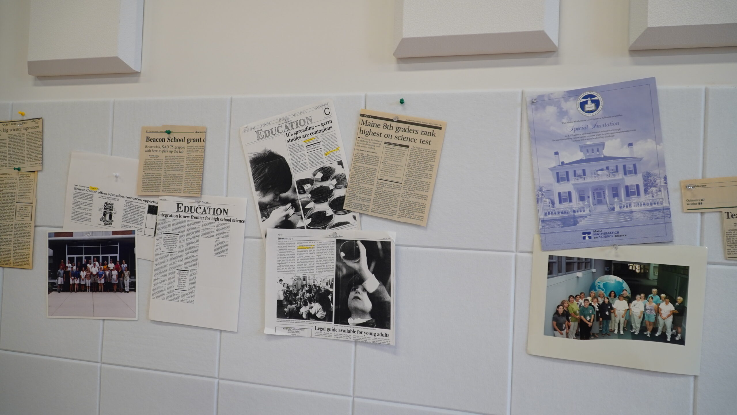 Scans and original newspaper clippings from MMSA's 30 year history hung on the wall.