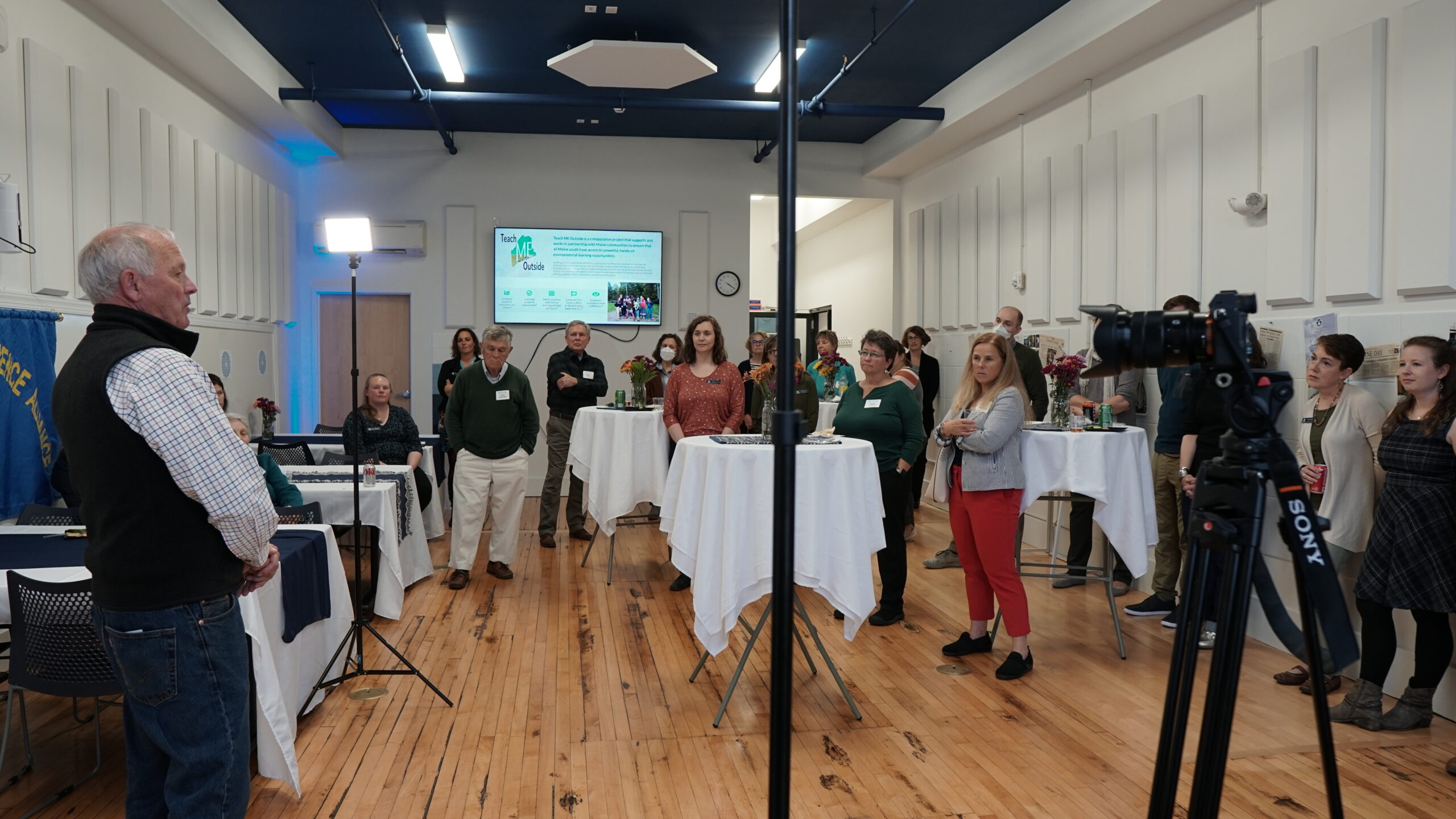 An image of Kevin London addressing a room of MMSA past and present staff as well as board members.