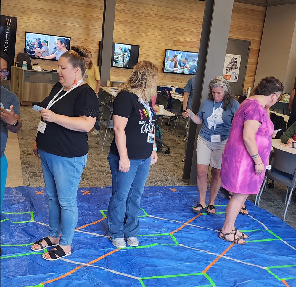 Educators mingle in a conference hall.