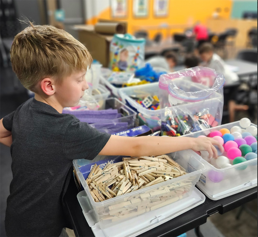 A child engages with materials for a STEM activity in North Carolina.