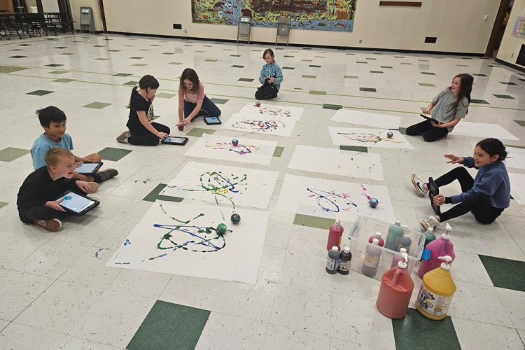 Children play with paint and iPads.